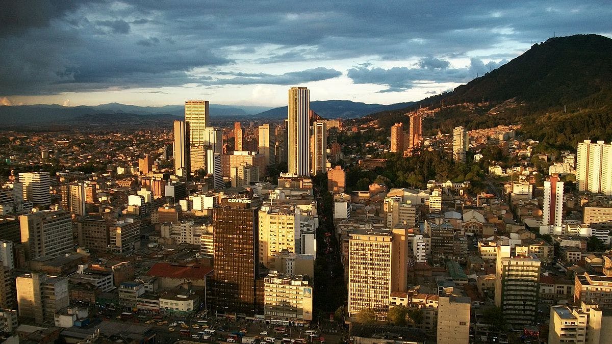 urban center of bogotá with green mountain in background
